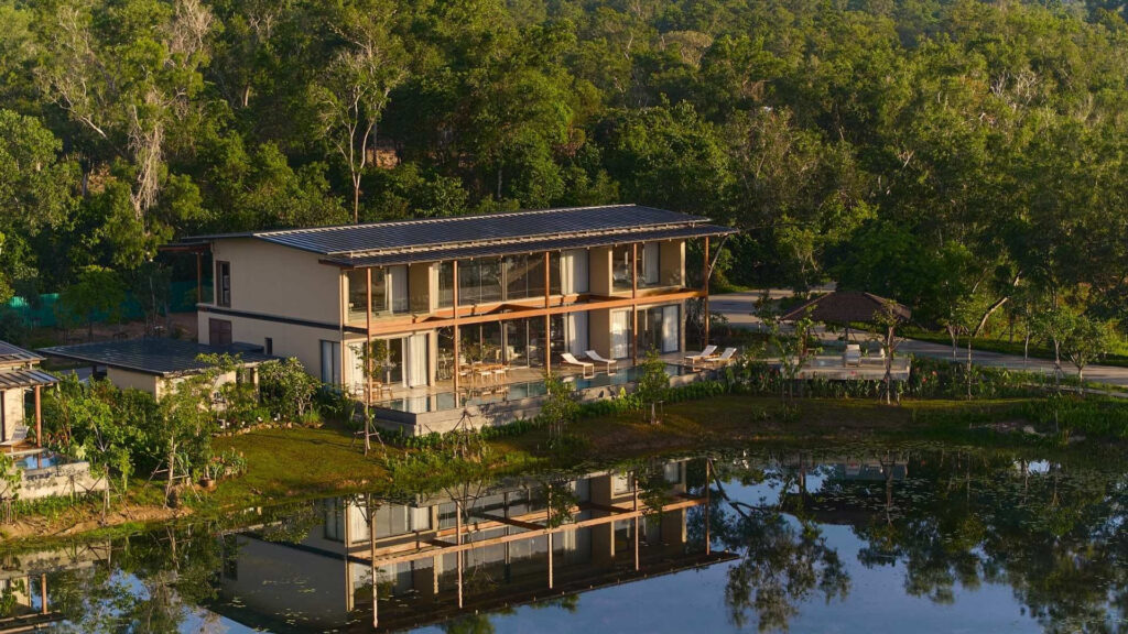 Lakefront pool villa reflected in the water