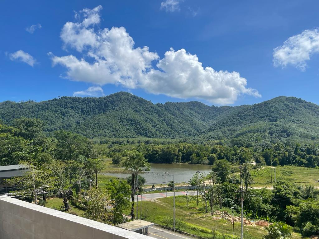 Hillside villa terrace overlooking river and forested mountains, Cherng Talay