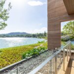 Timber terrace and sun loungers looking across the lake