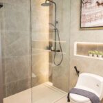 Stone-lined bathroom with rain shower, show residence, Surin
