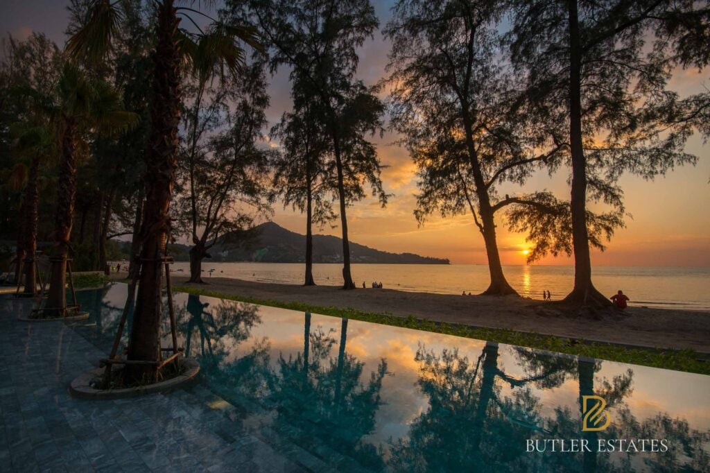 Infinity pool at sunset beside a tree-lined beach on Phuket’s west coast, from Rex Butler’s guide to the cost of living in Phuket