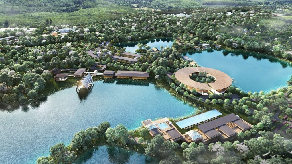 Aerial render of a round timber-roofed pavilion on a lake surrounded by forest, the Longevity Plaza at Tri Vananda in Thalang, Phuket.